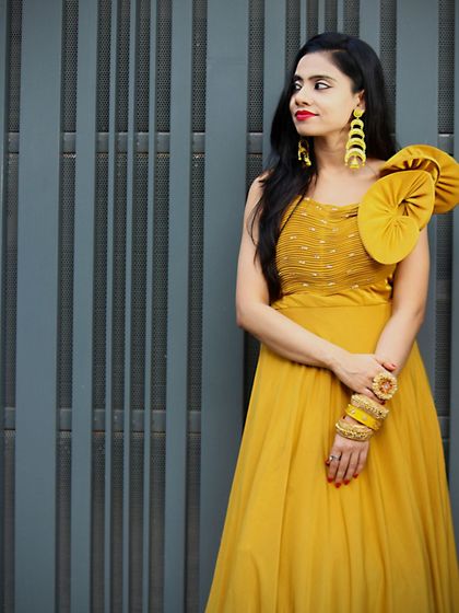 A side profile of the mustard gown, showing how it drapes beautifully.