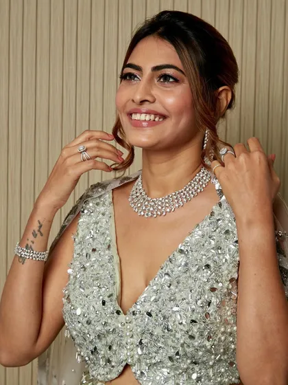 Adjusting her beautiful diamond jewelry. Every detail of this look, from the makeup to the accessories, came together perfectly.