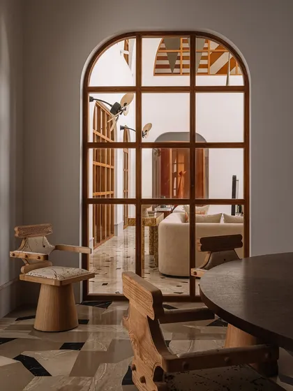 A view of our 'Kingpin' chairs in their natural habitat. The robust, sculptural form is crafted from ash wood with a comfortable upholstered seat, making them perfect for long, lingering dinners.