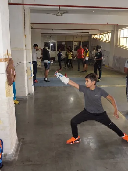 A young fencer practices his attack on a wall target. This solo drill is great for perfecting form and building confidence.