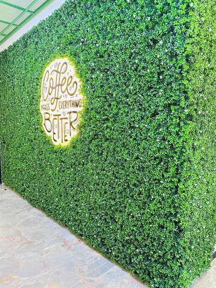 A slightly different angle of the coffee shop's logo wall, showing how the design looks from the side and its impressive three-dimensional presence in the space.