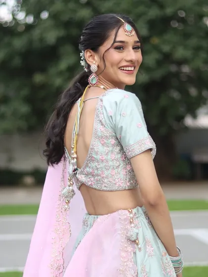 A happy, over-the-shoulder smile from the model, looking fresh and modern.
