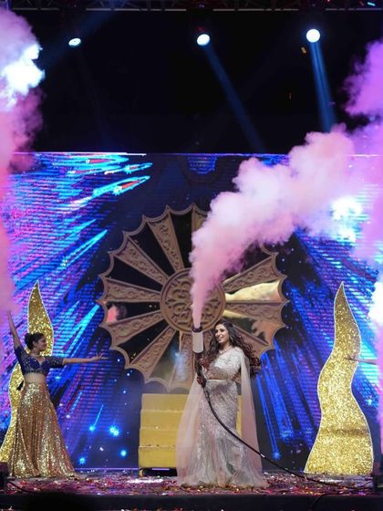 The bride takes center stage with a CO2 gun, adding a fun and modern twist to the Sangeet night. I encourage and plan for these moments of spontaneous fun.