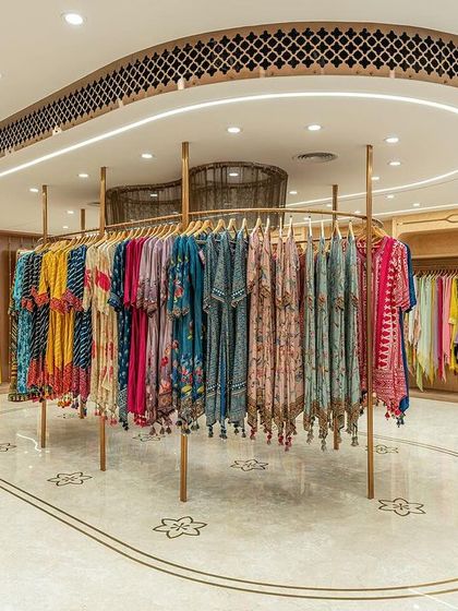 Custom-designed display units on the second floor encourage self-assisted shopping. The curved hanging rack creates a focal point and allows for an elegant presentation of the festive wear collection.