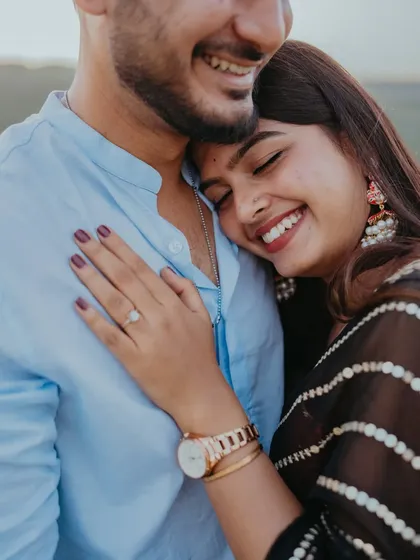A close-up shot capturing a joyful embrace and the bride-to-be's engagement ring. We focus on these details to tell a richer story of this special time in a couple's life.