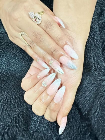 A soft and glamorous look with a sheer pink base, silver glitter ombre, and delicate silver line details.