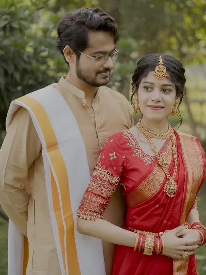 A beautiful portrait of a South Indian couple. We captured the groom's loving gaze as the bride looks on, showcasing their connection in traditional attire.