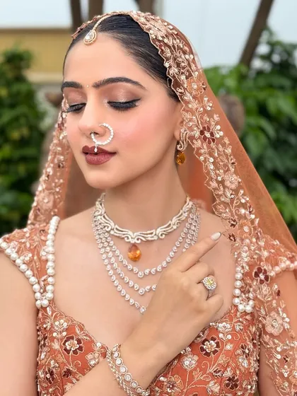 A close-up on the details. This shot highlights the intricate diamond jewelry and how the makeup, especially the defined eyes and lips, works in harmony with the accessories.