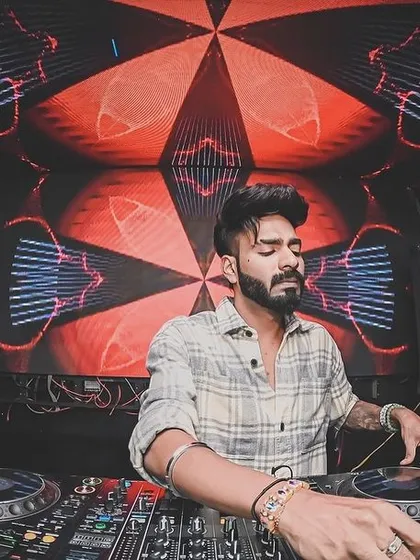 Focused and locked in. Behind the decks is my studio and my stage. Here, I'm reading the crowd, mixing tracks, and delivering the high energy sound I'm known for at a gig in Siliguri.