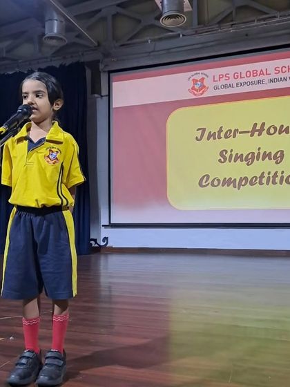 Another talented singer from the yellow house performs at the Inter-House Singing Competition.