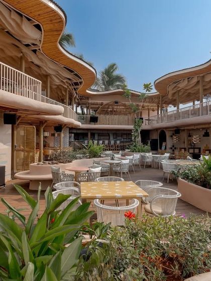 The seating arrangement at Dubki is designed to feel both communal and private. I used organic-shaped planters and varied furniture to break up the space, ensuring every table feels like its own little oasis.