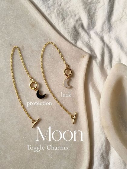 Tell me your birth month. Wearing your birthstone can be extra powerful. This image shows my Moon toggle charms in Black Onyx for protection and White Moonstone for luck.
