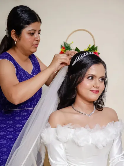 A candid moment of me securing the bride's tiara and veil. It's these final adjustments that ensure the bride feels secure and confident throughout her wedding day.