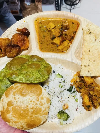 Another option for a party plate, this time featuring our popular thali items. This includes palak poori, paneer curry, vegetable rice, and other delicious sides.