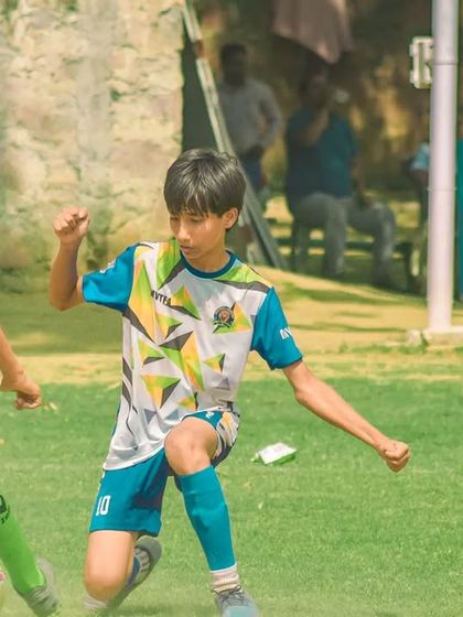 A player kneels to make a tackle, showing great defensive commitment.