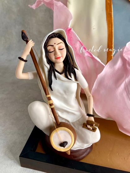 The serene posture and delicate details of the Meera Bai figurine, a central part of my gold-medal cake.