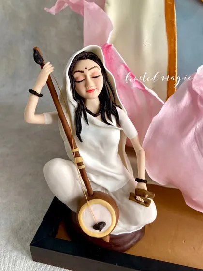 The serene posture and delicate details of the Meera Bai figurine, a central part of my gold-medal cake.