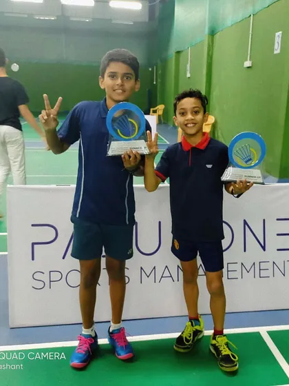 Our U-11 doubles team, Pragnay and Ashlon, celebrating their runner-up finish at the PSM Open Junior Badminton Tournament in Bangalore. Their victory sign shows their fantastic team spirit.
