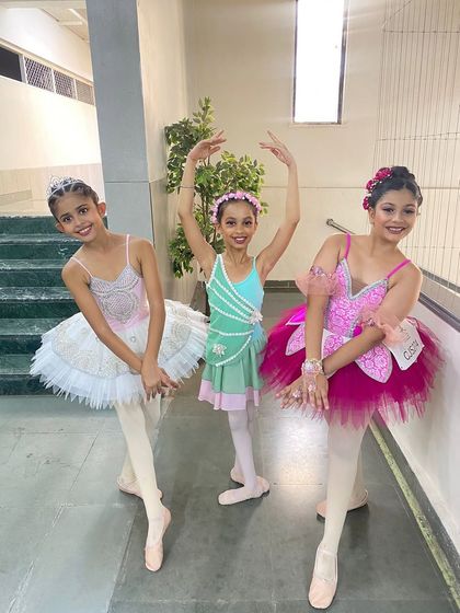 Ira with her fellow dancers in their beautiful performance costumes. These experiences on stage build the confidence needed for international auditions.