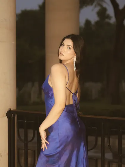 A night portrait from the rainy day shoot, using direct flash to freeze the moment. The flash creates a sharp, high-contrast look that separates the subject from the dark background.