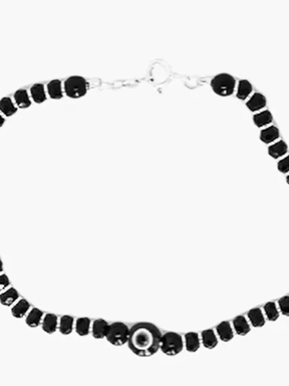 This evil eye bracelet is made with pure silver and black beads, a traditional combination in India for warding off the evil eye.