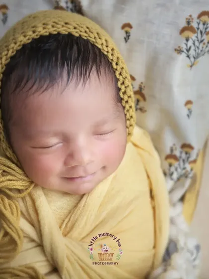 That little sleepy smile just melts my heart. Capturing these fleeting expressions is my favorite part of a newborn session. This little one is dreaming sweet dreams in a warm yellow wrap.