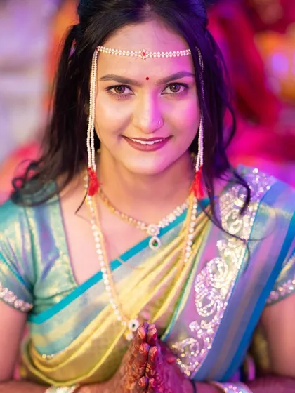 A close-up of the beautiful Marathi bride Ritu, showcasing her flawless engagement look. I enhanced her features with a subtle glow and a defined eye, letting her traditional 'mundavalya' and radiant smile be the focus.