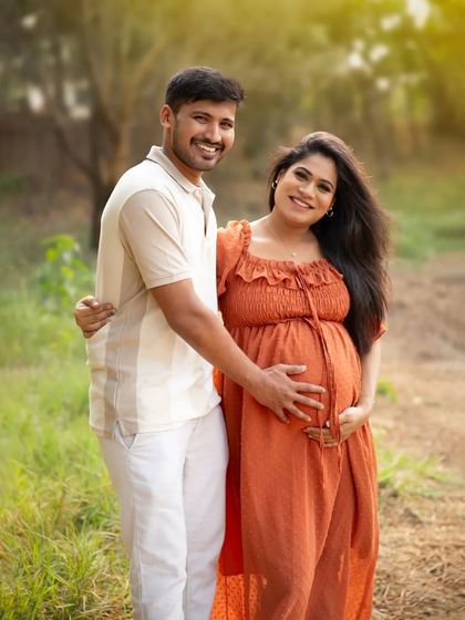 A loving embrace in a sun-dappled forest. This portrait perfectly captures the couple's happiness and the beautiful, natural light of an outdoor session.