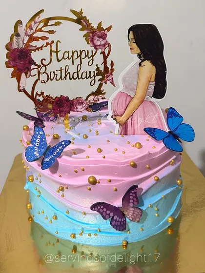 A special birthday cake for a mom-to-be. The pink and blue ombre design is complemented by butterfly accents and a beautiful topper.