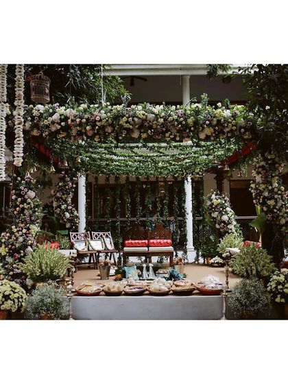 A garden-themed mandap using traditional Chettinad pillars, softened with contemporary flowers and greenery for a fresh, elegant look.