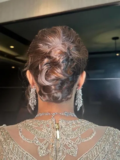 A classic messy updo, a versatile style that suits many different occasions and outfits.