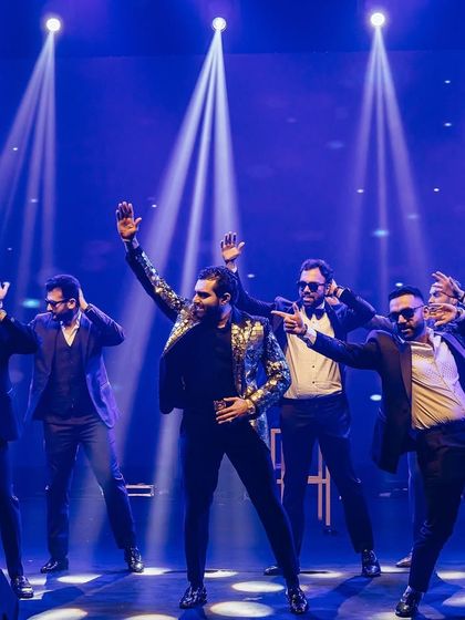 The groom and his squad command the stage with this powerful, high-energy routine. The sequined jackets and dramatic lighting added to the star quality of the performance.