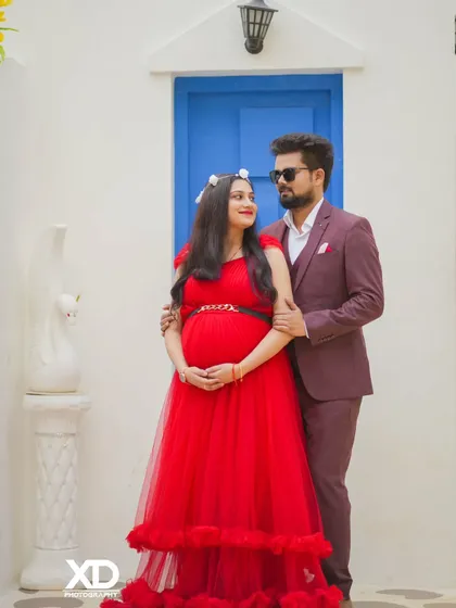 A stylish couple's portrait against the Santorini-inspired set, capturing a look of love and anticipation.