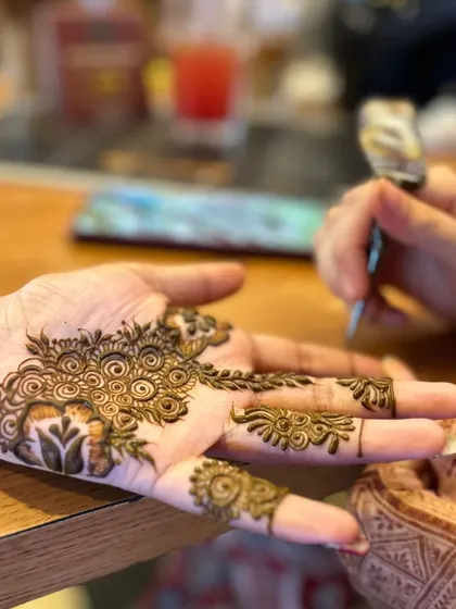 A close-up of the intricate work on the palm. You can see the texture of my organic henna paste.