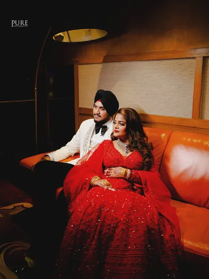 A candid moment of the couple enjoying their reception. Their relaxed poses and happy expressions show their comfort and love for each other.