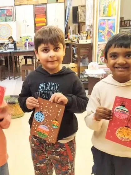 Our adorable toddler group proudly presents the Christmas cards they made. Using paint, glitter, and paper, they created unique and festive greetings for the holiday season.