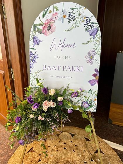 A lovely welcome sign for Rahil and Sadiya's Baat Pakki. The watercolor floral design on the sign was complemented by a fresh flower arrangement, setting a beautiful tone for the event.