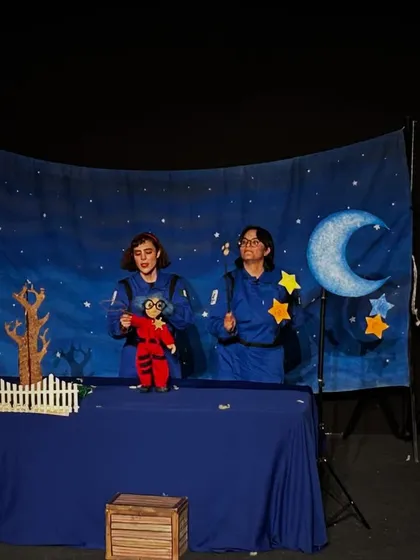 The two performers of 'Volar Volar' stand behind their stage, ready to take the audience on a colourful and musical adventure.