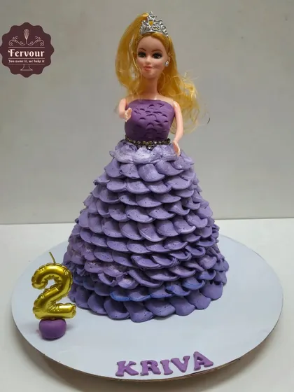 A classic doll cake with a beautiful purple ombre dress made entirely of piped whipped cream. This chocolate mousse cake is a timeless choice for a little girl's birthday, with zero fondant used on the dress.