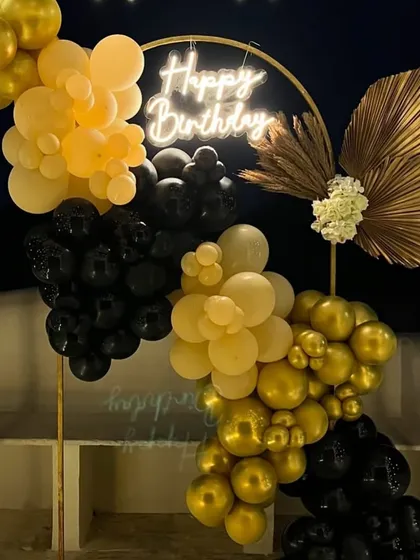A detailed view of the neon sign and balloons under the canopy.