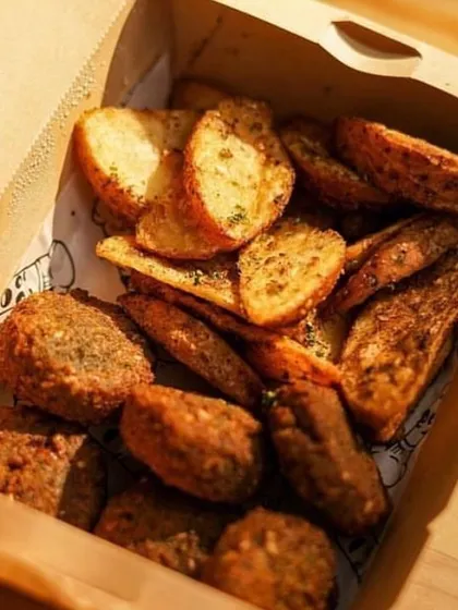 The perfect snack box for a football match. This box contains crispy falafel and seasoned potato wedges, essential components of my Lebanese Platter.
