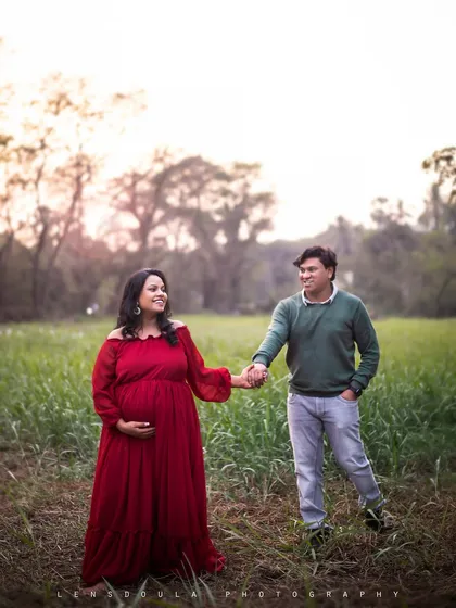 A sweet and simple moment of the couple holding hands and walking through a beautiful, open field.