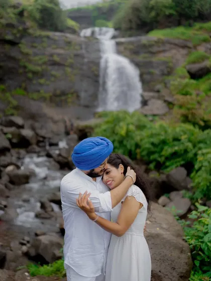 A tender hug that speaks volumes, captured in the serene environment of a waterfall pre-wedding shoot.