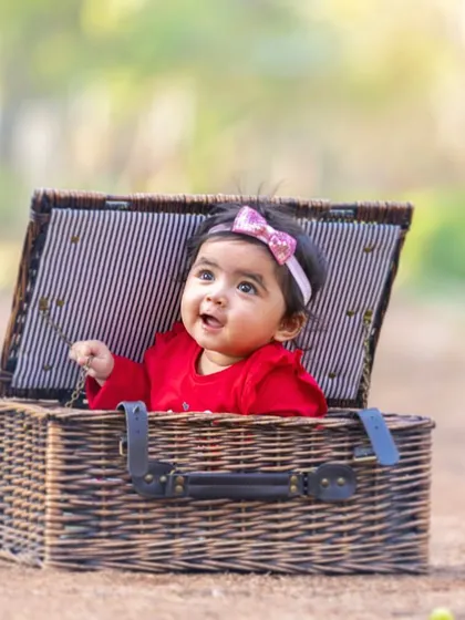 A perfect little surprise. Props like this picnic basket add a touch of playfulness to the session while keeping the baby safely and adorably contained.