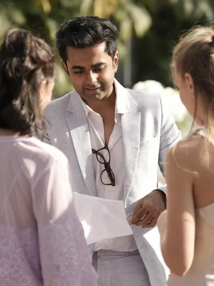 A group of guests gathered around to witness some close-up magic. This format is perfect for daytime functions, allowing me to bring the entertainment directly to your friends and family.