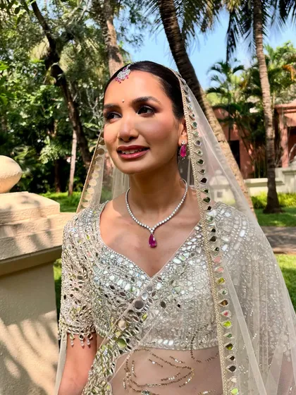A beautiful outdoor shot of the Goa bride. Her makeup is holding up perfectly in the sun, and the pop of ruby in her jewelry adds a touch of color.
