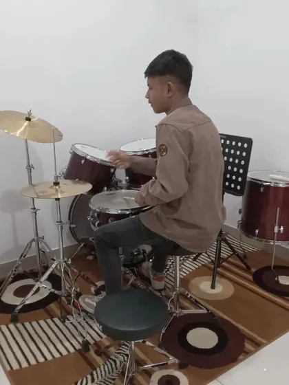 A student practicing on the drum kit. We provide a complete setup for our drum students.