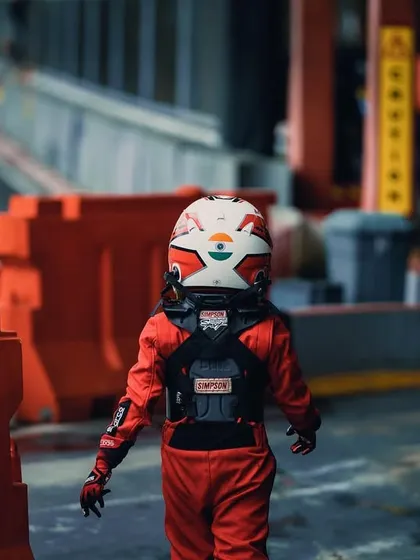 A young driver walks through the paddock at the Rok Cup Singapore.