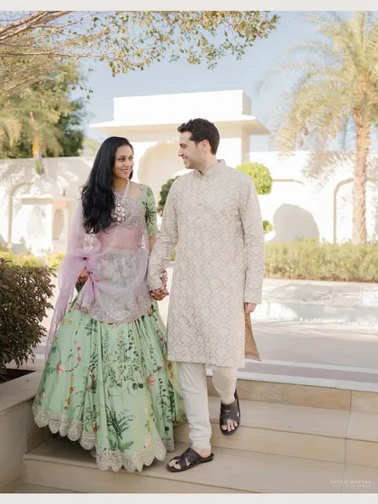 Walking hand-in-hand through the pristine grounds of a Jaipur resort. This photo captures a simple, happy moment that feels both candid and elegant.
