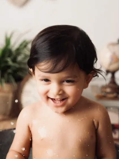 A huge, giggling smile from the baby in the tub. This is what pure, unadulterated happiness looks like.
